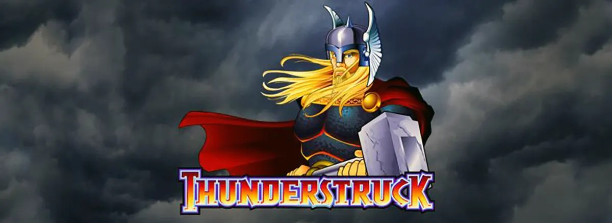 “Thunderstruck slot splash image showing a Viking/Thor-like warrior in a winged silver helmet with long blond hair and a flowing red cape, holding a large hammer against dark storm clouds, with the ‘Thunderstruck’ logo centered at the bottom.”